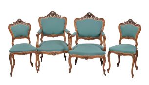A set of four French carved walnut and upholstered salon chairs , comprising a pair of armchairs,