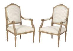 A pair of green painted and carved wood armchairs , in Louis XVI style , late 19th century,
