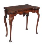 A George II Irish mahogany folding card table, circa 1750, the rectangular top with rounded outset