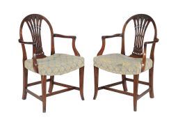 A harlequin set of mahogany eight dining chairs, comprising a set of six George III shield back