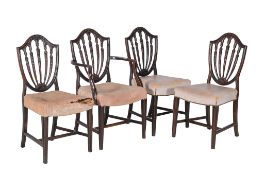 A set of four George III mahogany dining chairs, to include one armchair