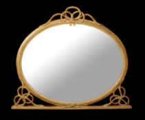 A George IV giltwood and composition wall mirror, circa 1825, the oval plate within a rope