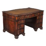 A mahogany pedestal desk in George III style, circa 1900, of serpentine sided form, 75cm high,