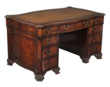 A mahogany pedestal desk in George III style, circa 1900, of serpentine sided form, 75cm high,