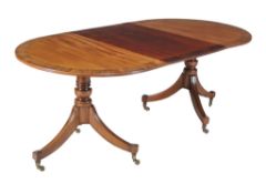 Ω A mahogany and rosewood banded twin pedestal dining table in Regency style, first quarter 20th