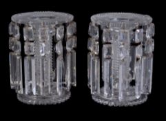 A pair of Regency cut glass lustre candlesticks, circa 1815, each with broad, flat and ray-cut drip