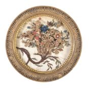A George III circular paper-scroll picture , circa 1780, depicting a spray of flowers within a