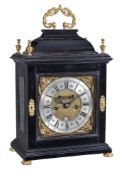 Ω A fine Queen Anne gilt brass mounted ebony table clock with pull-quarter repeat Isaac