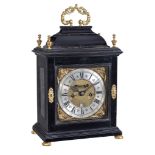 Ω A fine Queen Anne gilt brass mounted ebony table clock with pull-quarter repeat Isaac