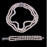 A cultured pearl, diamond and emerald necklace, the three strands of uniform cultured pearls, to