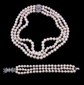 A cultured pearl, diamond and emerald necklace, the three strands of uniform cultured pearls, to