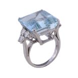 An aquamarine and diamond ring, the rectangular cut aquamarine, claw set between brilliant cut