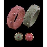 A shagreen and ruby bangle, the pink shagreen set with oval cabochon rubies in collet settings,