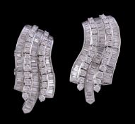 A pair of diamond earrings, the curved panels set with brilliant cut and baguette cut diamonds,