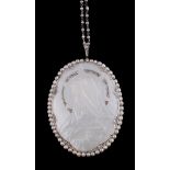 Ω A French mother of pearl, diamond and seed pearl pendant by Lubary, circa 1920, the oval mother