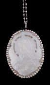 Ω A French mother of pearl, diamond and seed pearl pendant by Lubary, circa 1920, the oval mother