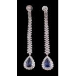 A pair of sapphire and diamond earrings, the pear cut sapphires collet within a surround of