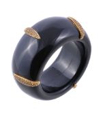 An onyx & yellow sapphire bangle, the polished onyx band with applied navette shaped gold coloured