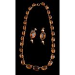 A late Victorian citrine riviere necklace, circa 1900, the graduated oval cut citrines in cut down