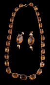 A late Victorian citrine riviere necklace, circa 1900, the graduated oval cut citrines in cut down