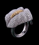 A diamond and emerald peace lily ring, the flower head pave set with brilliant cut diamonds, the