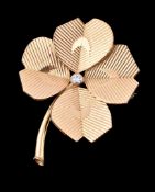 A 1960s 18 carat gold and diamond clover brooch by Cartier, designed as a four leaf clover set with