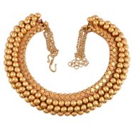 An Indian gold coloured necklace, the articulated panels with polished and quatrefoil decoration,