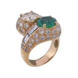 An emerald and diamond crossover dress ring, the brilliant cut diamond weighing 1.84 carats, and