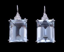 A pair of aquamarine and diamond earrings, the rectangular cut aquamarine below a trefoil of