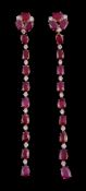 A pair of ruby and diamond earrings, the articulated drops set with alternating oval cut rubies and