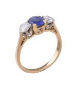 A sapphire and diamond three stone ring, the oval cut sapphire between two brilliant cut diamonds,