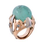 An emerald and diamond dress ring, the tumbled emerald within a two colour surround set with