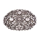 An early Victorian diamond oval brooch, circa 1840, the pierced scrolled foliate gold backed silver