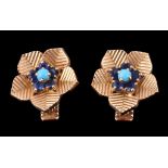 A pair of 1960s sapphire and turquoise ear clips by Cartier, designed as flower heads, centrally