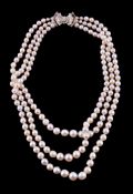 A three strand cultured pearl and diamond necklace, the three rows with graduating cultured pearls,