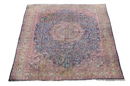 A Tabriz carpet, the polychrome medallion within a navy field decorated profusely with floral