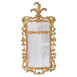 A George III carved giltwood wall mirror , circa 1770, the divided plate within the shaped frame