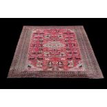 A Khorassan carpet, the red field decorated with animals in polychrome throughout, including