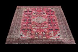 A Khorassan carpet, the red field decorated with animals in polychrome throughout, including