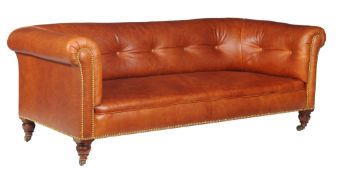 A Victorian walnut and buttoned leather upholstered sofa, by R GARNETT & SONS , circa 1860, with
