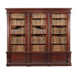A mahogany library bookcase, circa 1890, the dentil and tongue and dart moulded cornice above three