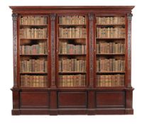 A mahogany library bookcase, circa 1890, the dentil and tongue and dart moulded cornice above three