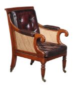 A Regency mahogany library armchair, circa 1815, with padded arms terminating in scroll terminals,