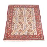 An Isfahan carpet, the pale field decorated with a design of undulating rows of flowers in red,