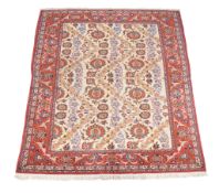 An Isfahan carpet, the pale field decorated with a design of undulating rows of flowers in red,