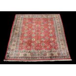 A Tabriz carpet , the madder field decorated with meandering foliate branches and flowerheads in an