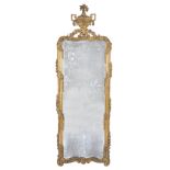 A Louis XV carved giltwood wall mirror, circa 1760, the rectangular plate within a moulded frame