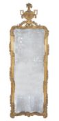 A Louis XV carved giltwood wall mirror, circa 1760, the rectangular plate within a moulded frame