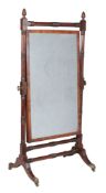 A George IV mahogany cheval mirror , circa 1825, with acorn pattern finials above turned uprights,