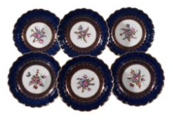 Six Worcester blue-ground plates, circa 1770 , the centres painted with floral sprays within gilt